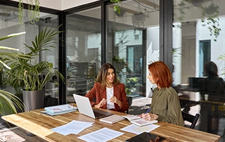 Manager conducting a performance review meeting with an employee in January