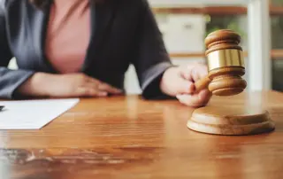 Employment compliance investigator reviewing workforce records during a workplace inspection